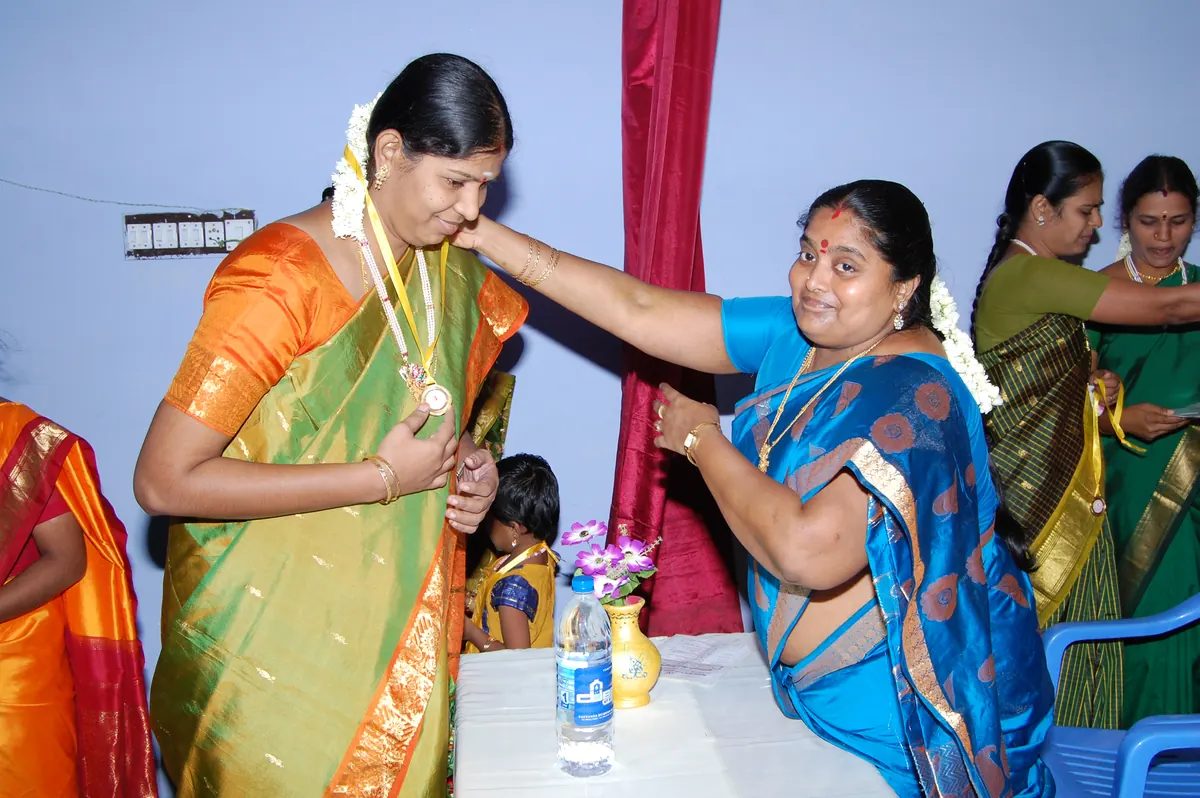 SHG leader receiving medal of honour for excellent bank loan repayment performance in 2014