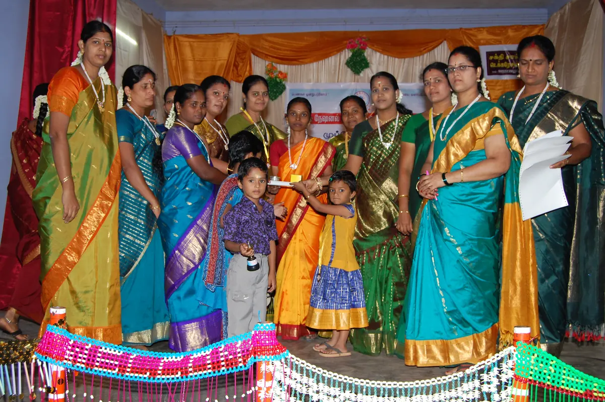 Women graduates displaying certificates after completing the one-year Diploma in Tailoring