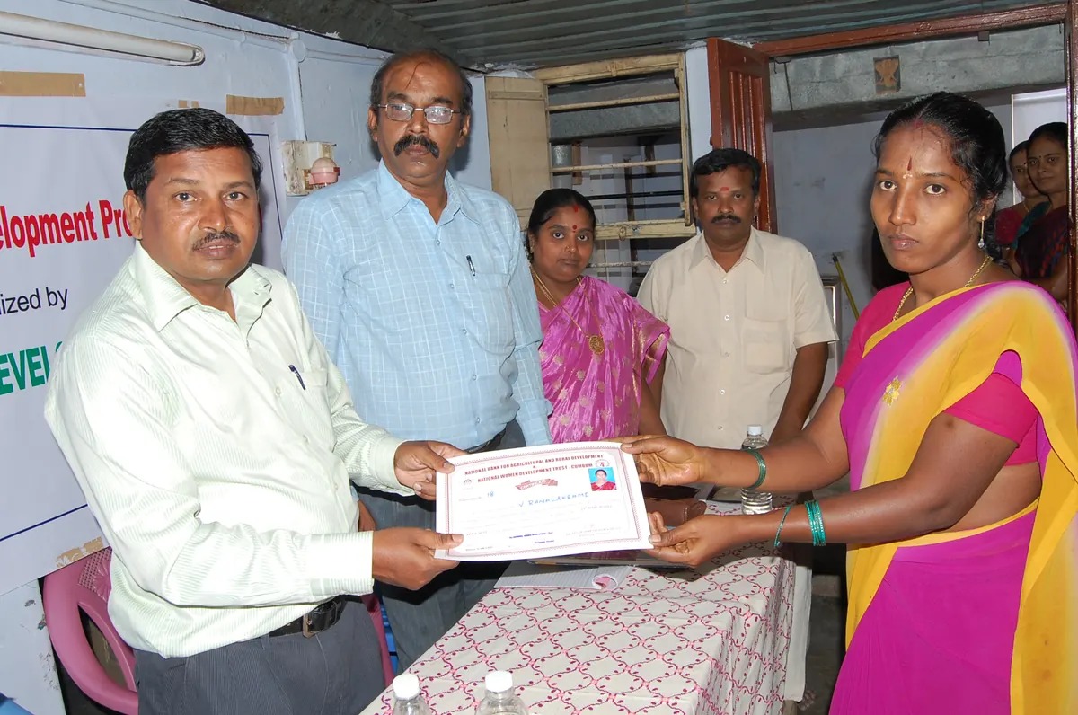 SHG member receiving official NABARD vocational training qualification certificate in 2015