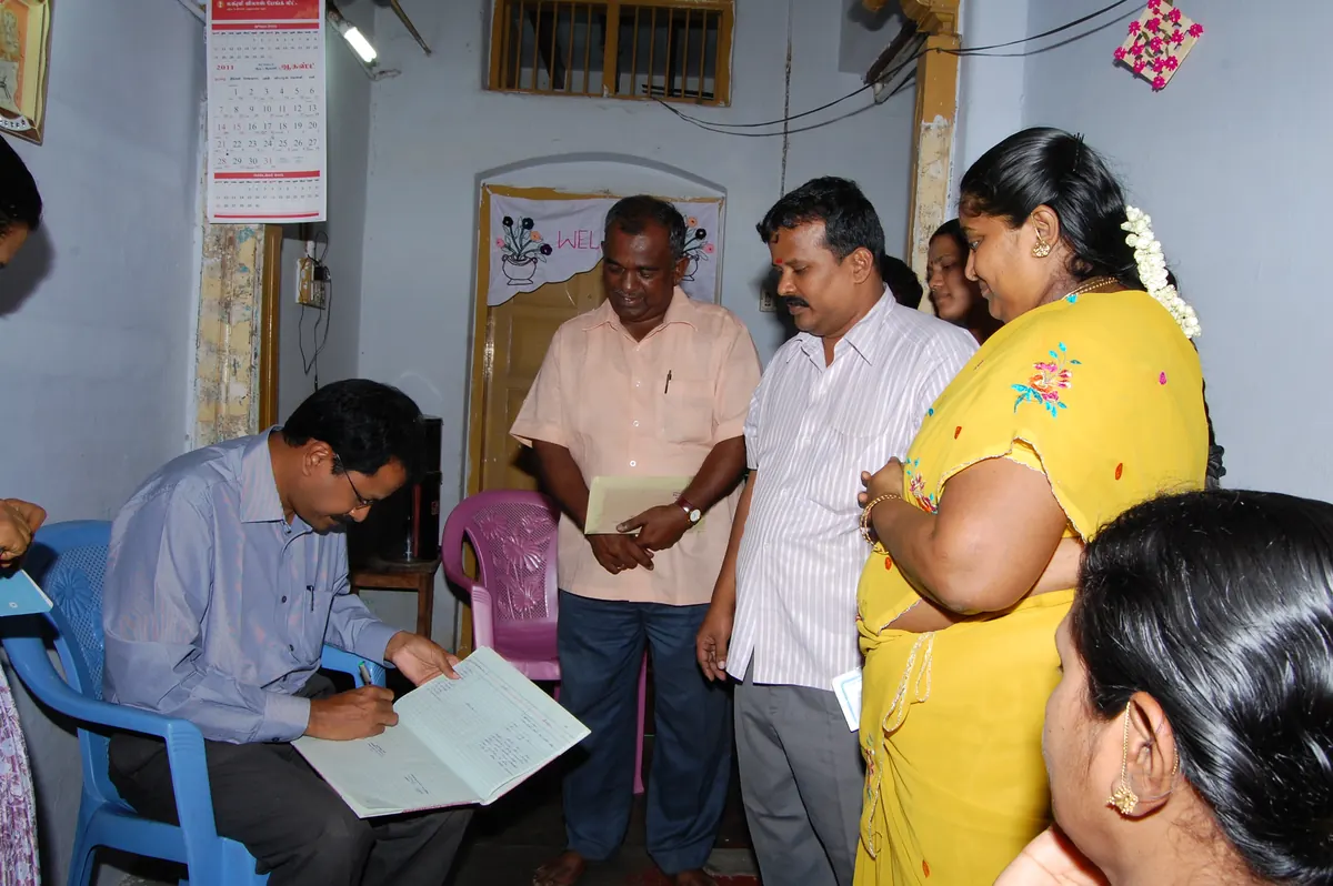 Theni District Collector Mr. Palanichamy writing observations in NWDT visitors register