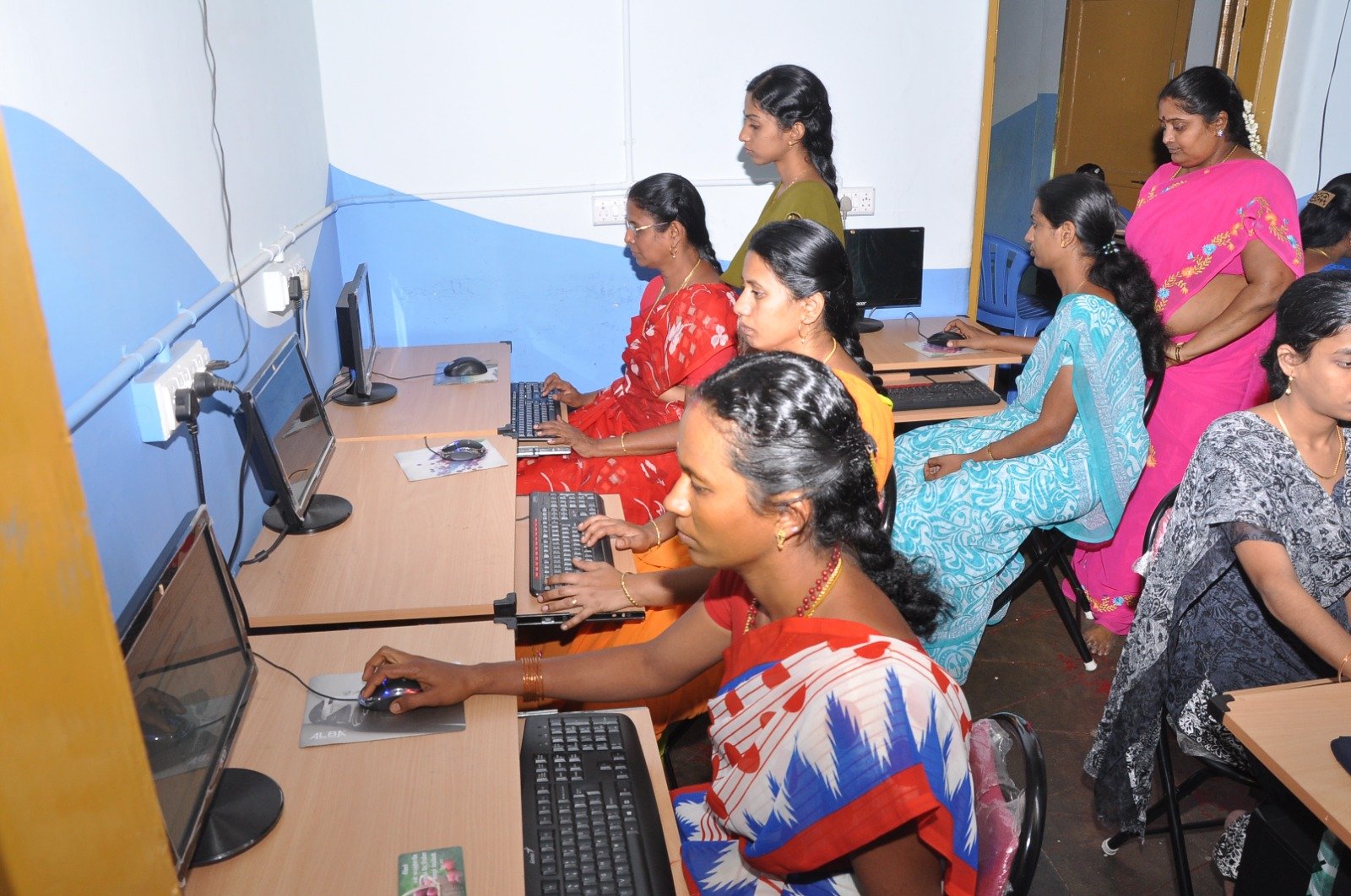 Women trainees working diligently at computer terminals in NWDT training centre