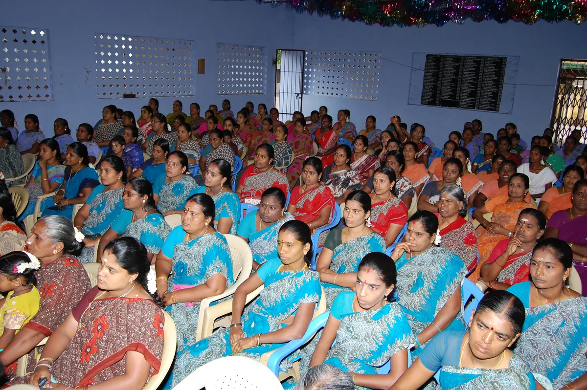 Women Self-Help Group members in uniform sarees receiving SBI credit support in 2012